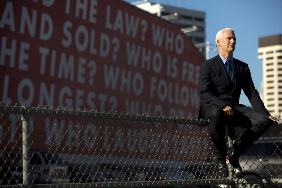 Klaus Biesenbach, new director of the Los Angeles Museum of Contemporary Art, in front of Barbara Kruger's mural that asks "Who is beyond the law?" Civic-mindedness and creating dialogue with the city are central to his mission at MOCA.