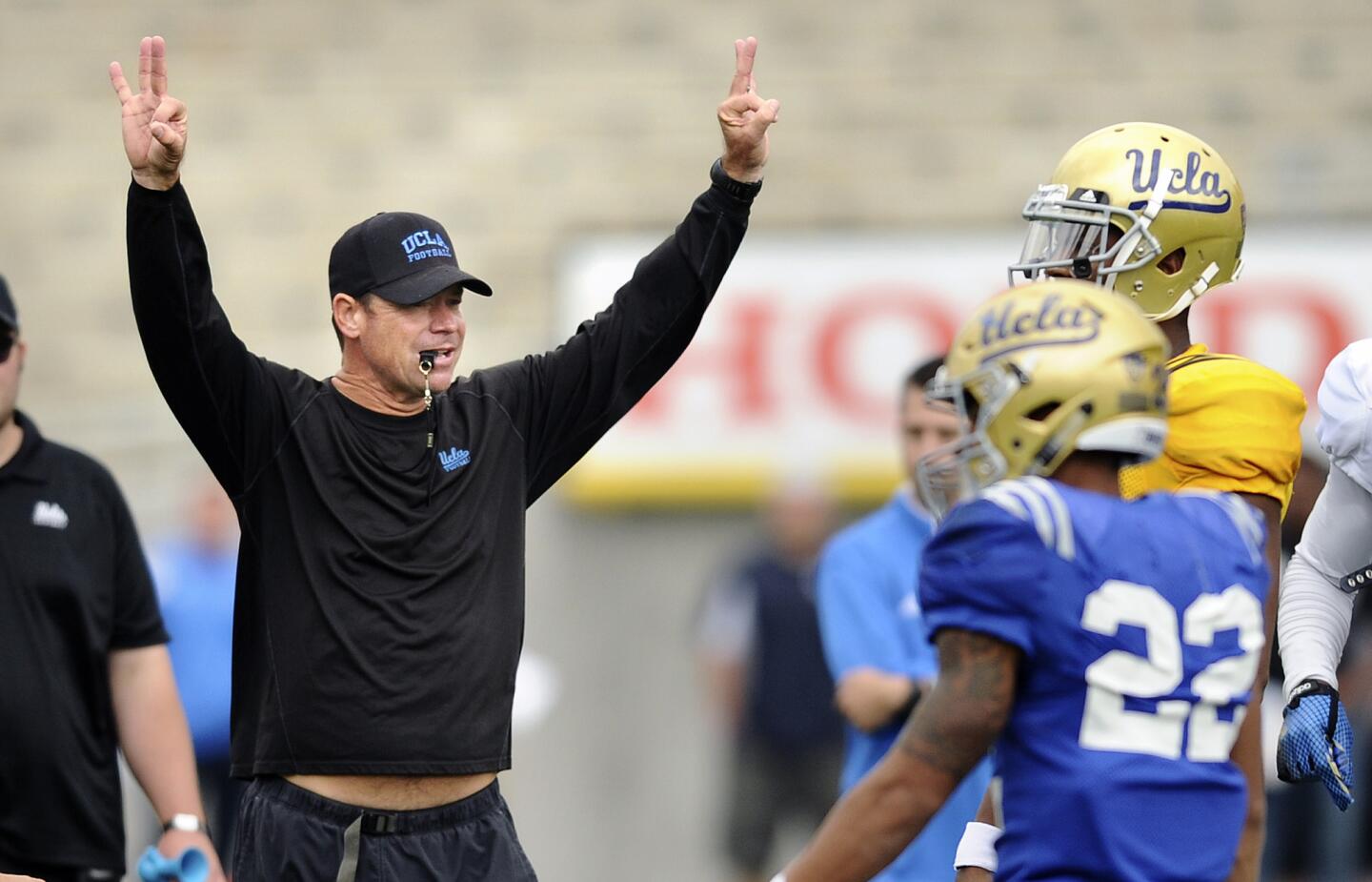UCLA head coach Jim Mora calls a play during the spring football game at the Rose Bowl on Saturday.