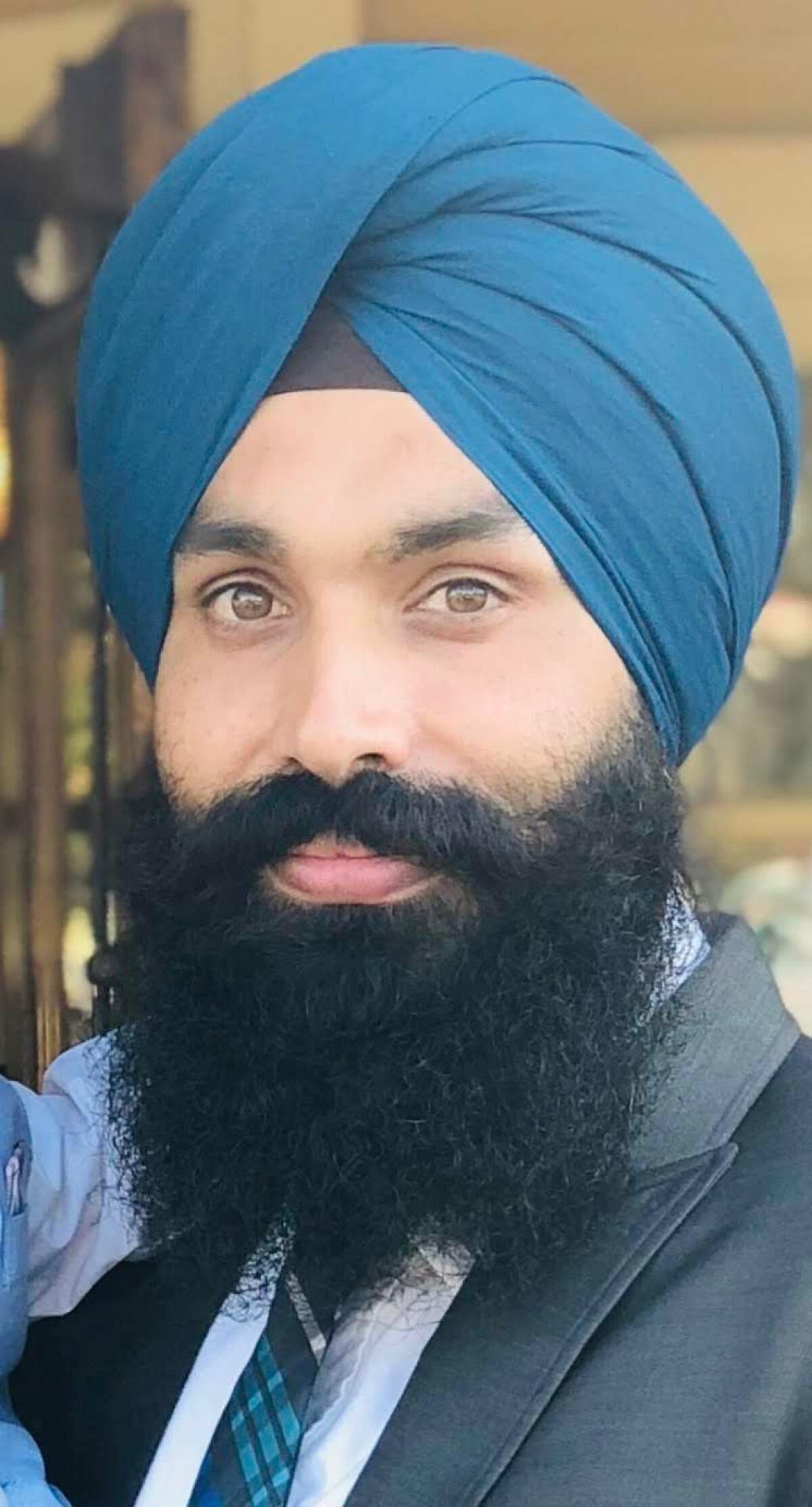 Taptejdeep Singh wears a turban and smiles.