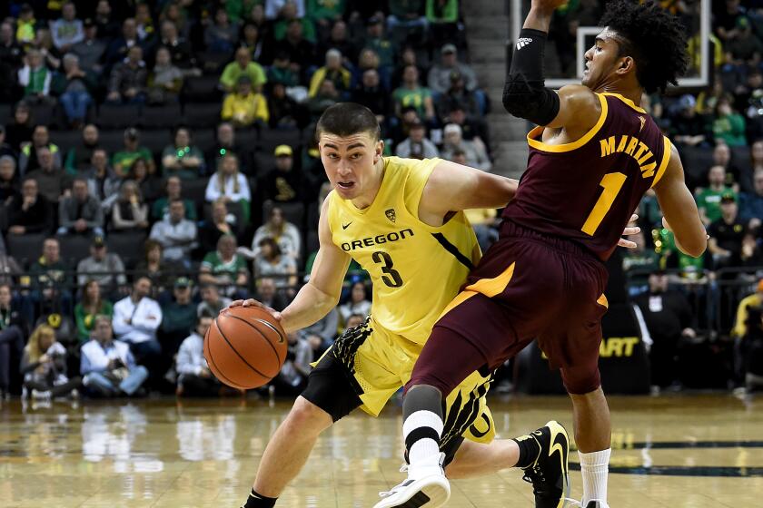 EUGENE, OREGON - JANUARY 11: Payton Pritchard #3 of the Oregon Ducks drives to the basket on Remy Martin #1 of the Arizona State Sun Devils during the first half at Matthew Knight Arena on January 11, 2020 in Eugene, Oregon. (Photo by Steve Dykes/Getty Images)