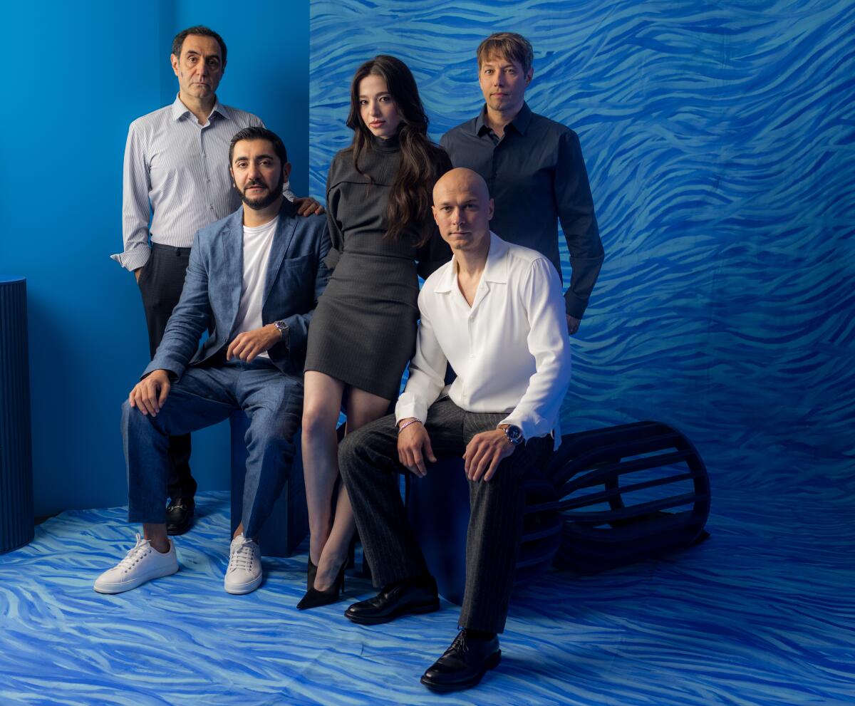 A cast and its director pose for a photograph.