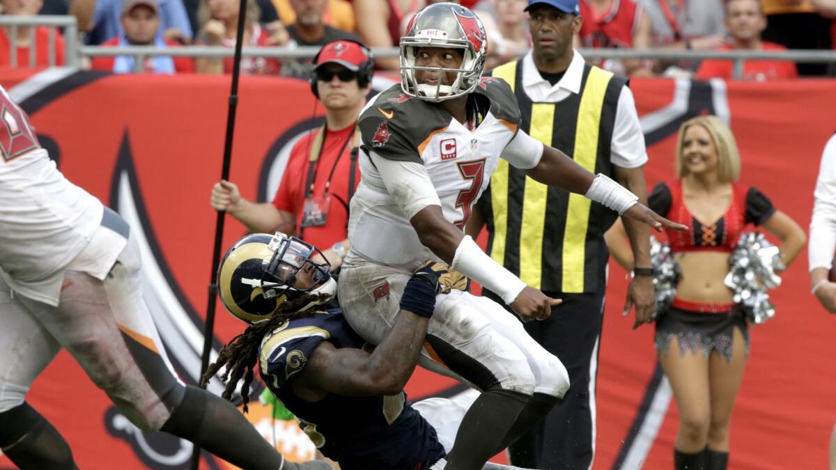 Buccaneers quarterback Jameis Winston just releases a pass before Rams linebacker Mark Barron can sack him.