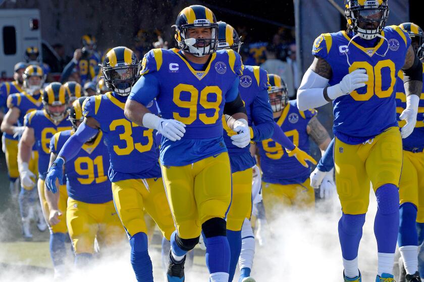 LOS ANGELES, CA - DECEMBER 29: Defensive tackle Aaron Donald #99 of the Los Angeles Rams leads the team on to the field for the game against the Arizona Cardinals at the Los Angeles Memorial Coliseum on December 29, 2019 in Los Angeles, California. (Photo by Jayne Kamin-Oncea/Getty Images)