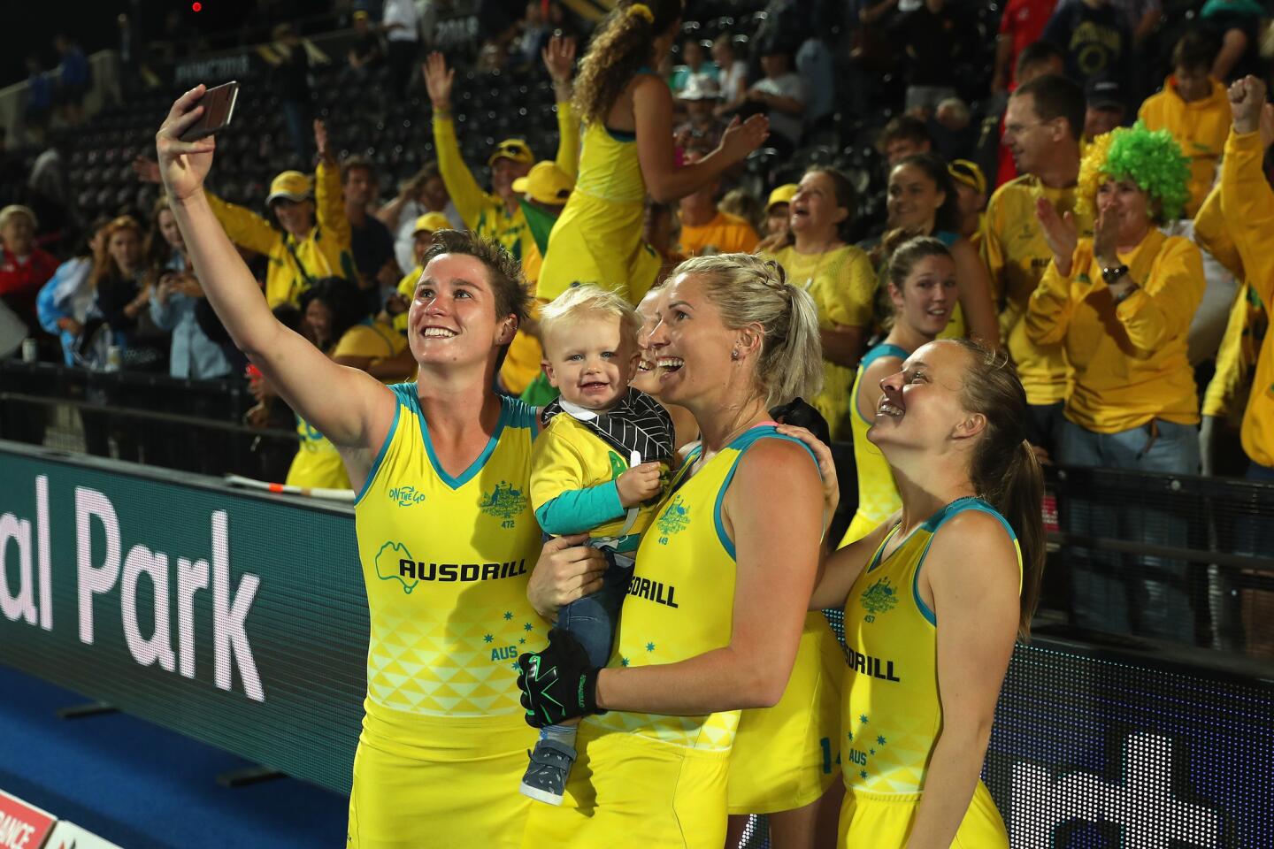 LONDON, ENGLAND - AUGUST 01: Kathryn Slattery of Australia, Jodie Kenny of Australia and Emily Smith of Australia pose for a selfie with family members after their victory during the Quarter Final game between Australia and Argentina of the FIH Womens Hockey World Cup at Lee Valley Hockey and Tennis Centre on August 1, 2018 in London, England. (Photo by Christopher Lee/Getty Images) ** OUTS - ELSENT, FPG, CM - OUTS * NM, PH, VA if sourced by CT, LA or MoD **