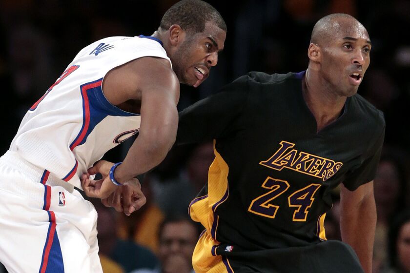 Lakers guard Kobe Bryant (24) tries to gain position against Clippers point guard Chris Paul during a game in 2014.