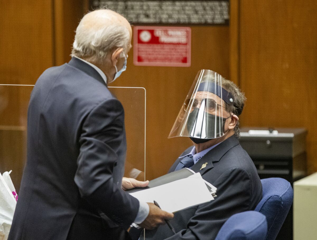 George Tyndall, right, USC's former longtime campus gynecologist, confers with attorney Leonard Levine.