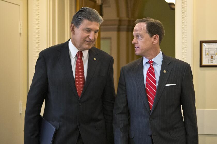 Sen. Joe Manchin, D-W.Va. and Sen. Patrick Toomey, R-Pa. arrive for a news conference on Capitol Hill