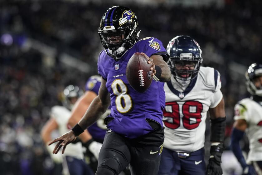 Baltimore Ravens quarterback Lamar Jackson (8) runs into the end zone for a touchdown.