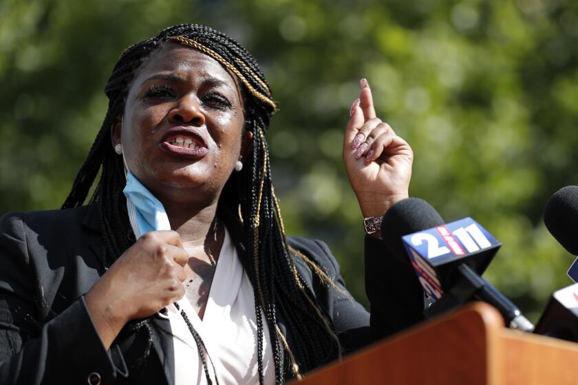 Activist Cori Bush speaks during a news conference Wednesday, Aug. 5, 2020, in St. Louis. Bush pulled a political upset on Tuesday, beating incumbent Rep. William Lacy Clay in Missouri's 1st District Democratic primary. (AP Photo/Jeff Roberson)