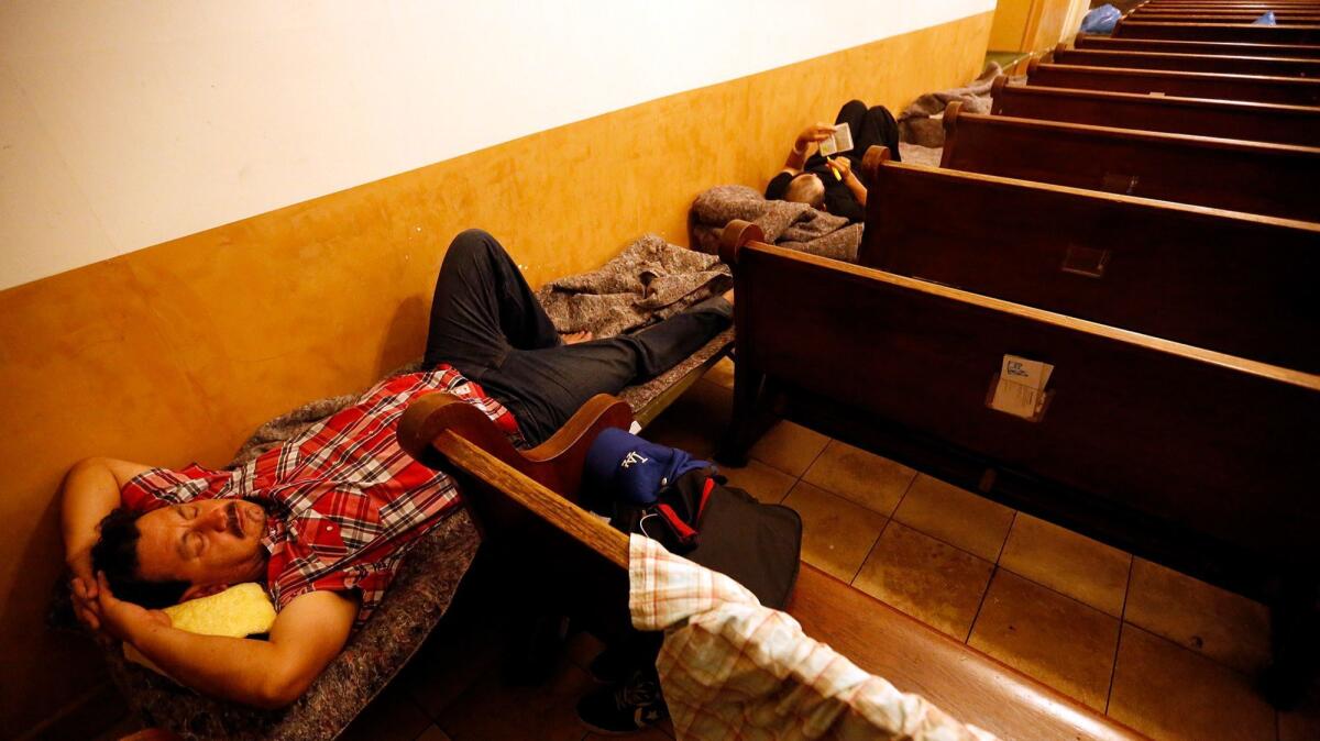 Gelacio Barraza, 42, prepares to bed down for the night at a facility that offers shelter to the homeless in Los Angeles.