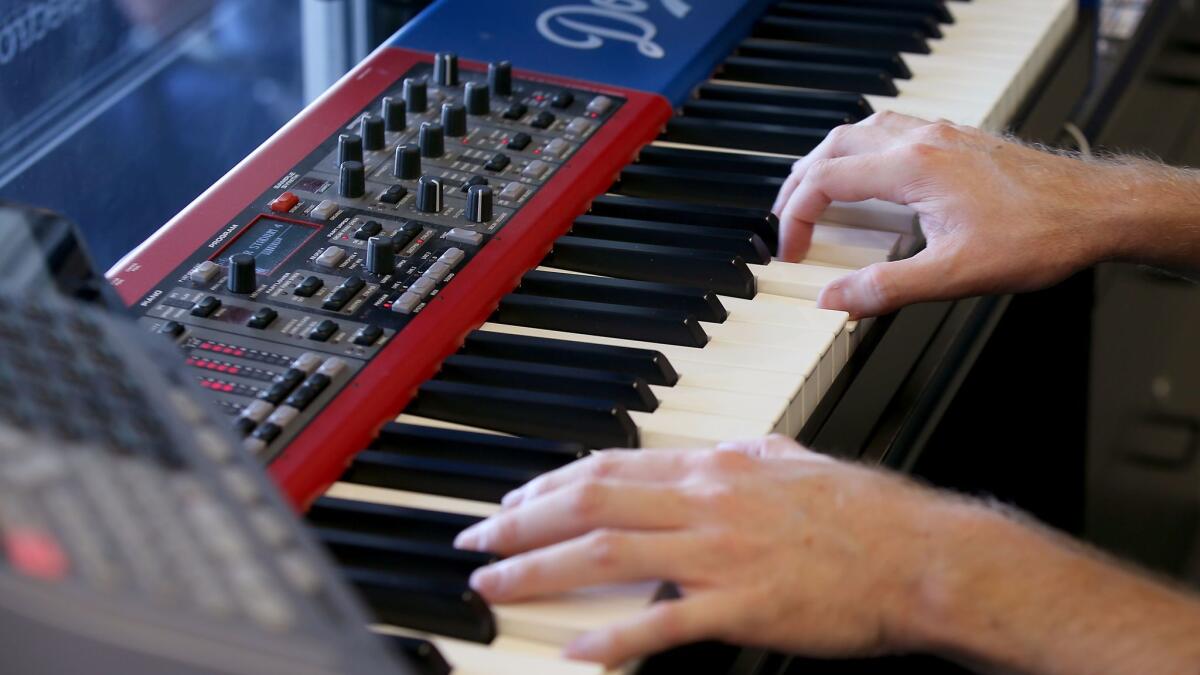 Dieter Ruehle goes to work on the Nord electronic keyboard he plays as organist for the Los Angeles Dodgers.