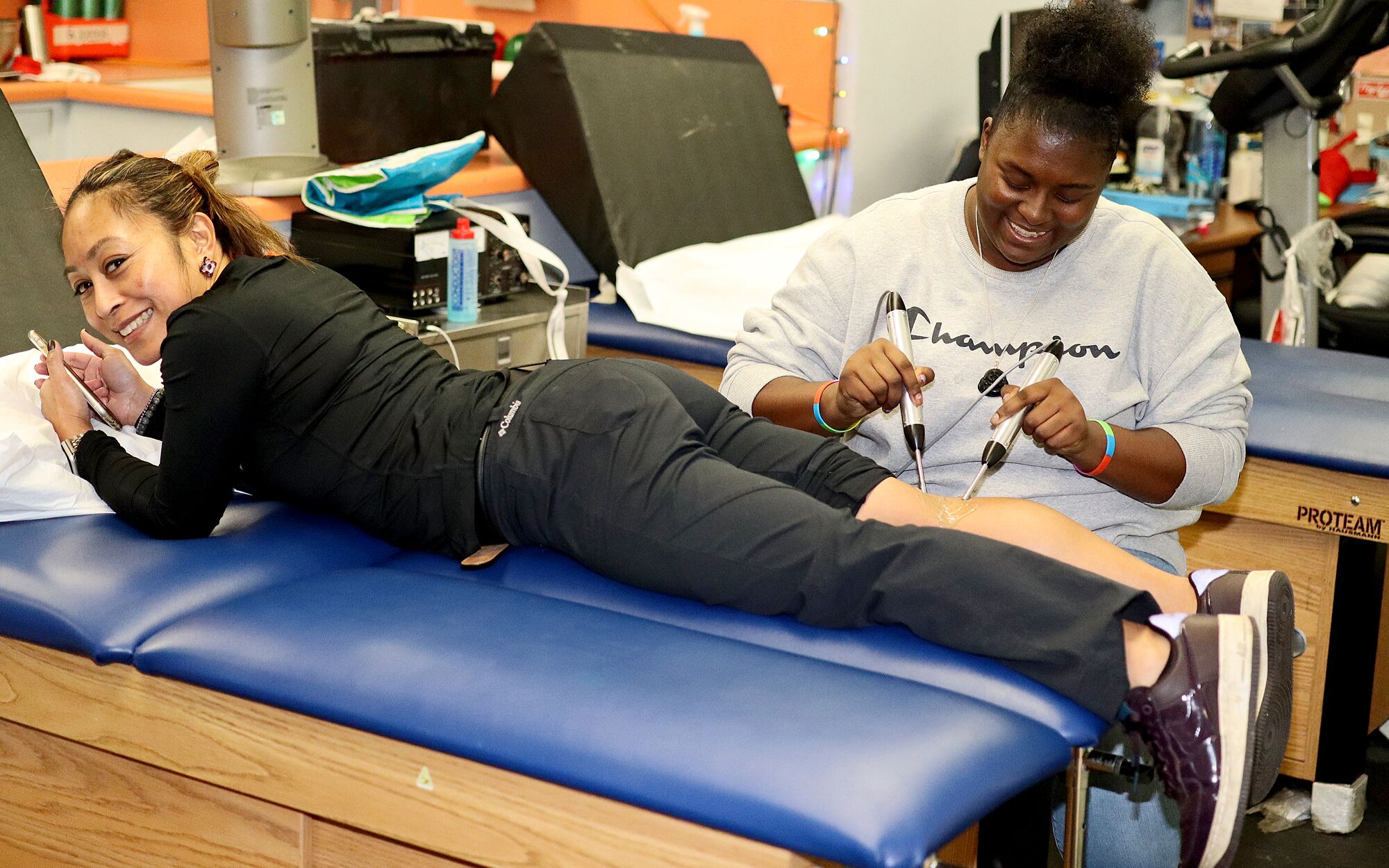 Crenshaw athletic trainer Ellen Kelly is on the receiving end of a training exercise as part of the Team HEAL program.