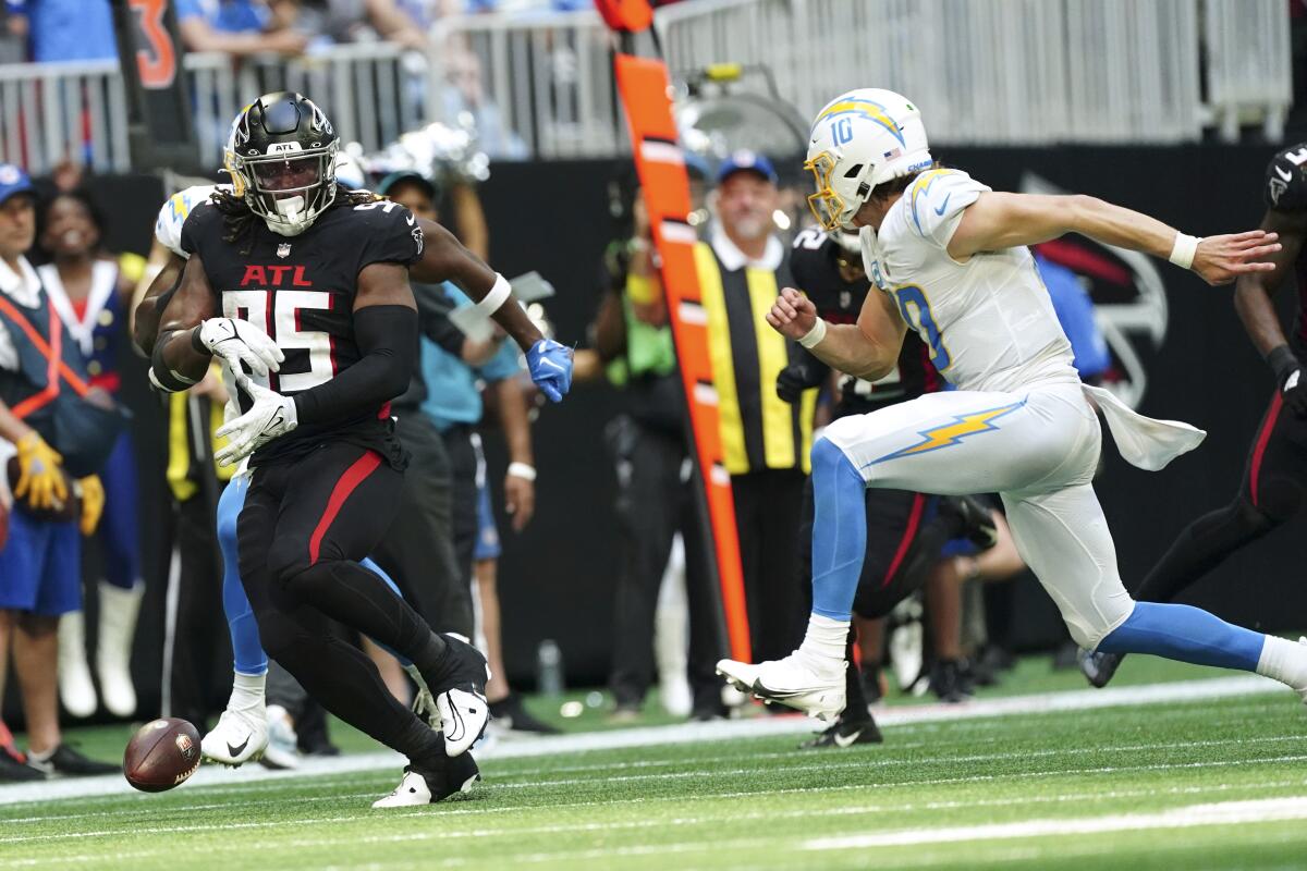 The Falcons' Ta'Quon Graham (95) fumbles the football back to the Chargers after recovering an Austin Ekeler fumble.