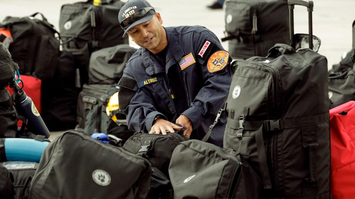 Daniel Altruz, a member of the Los Angeles County Urban Search and Rescue team, gets ready for deployment in Mexico or Puerto Rico.