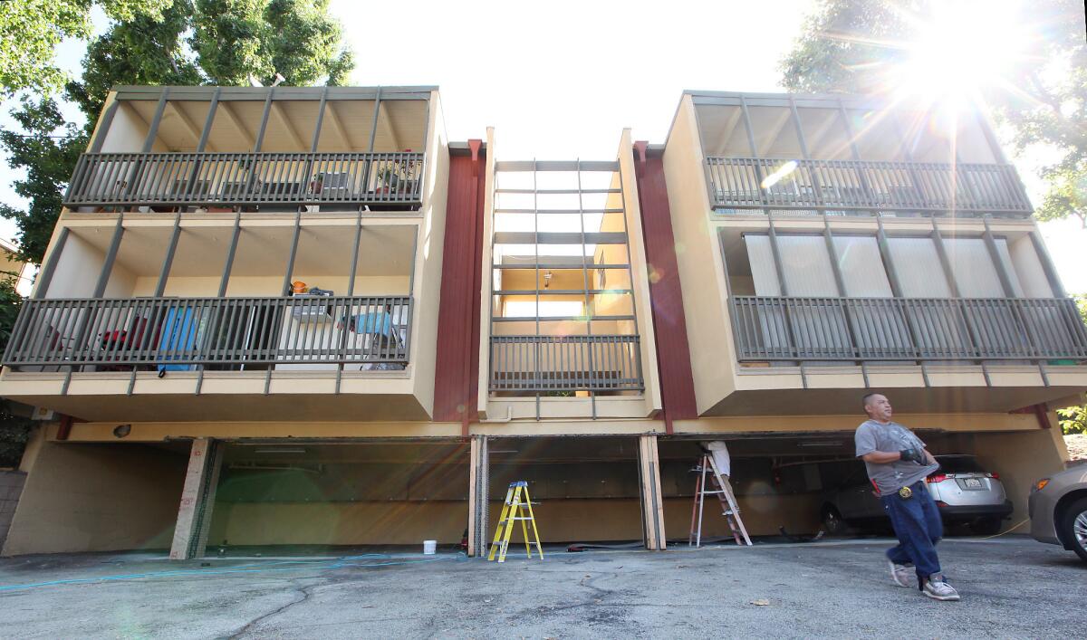 Construction workers seismically retrofit an apartment building in Montrose on Friday.