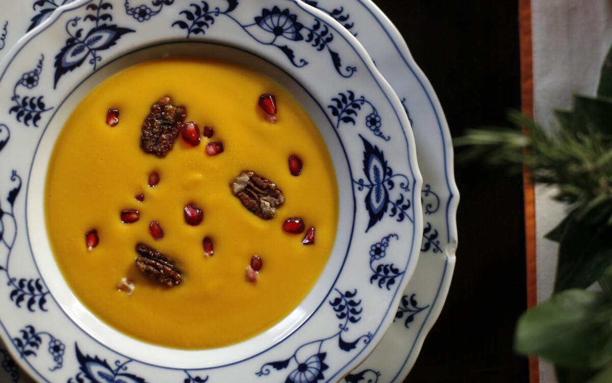 Kabocha squash soup with pomegranate seeds and spicy candied pecans