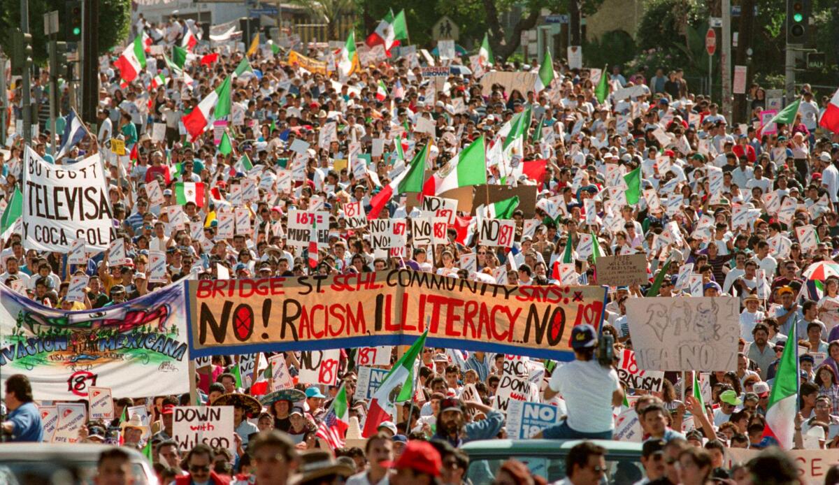 Oct. 16, 1994: Thousands march down Cesar Chavez Avenue near downtown Los Angeles denouncing Proposition 187, which would deny services to immigrants in the country illegally.