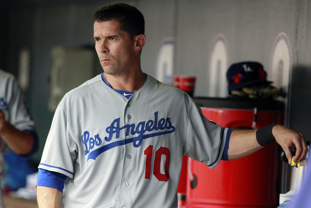 Dodgers infielder Michael Young walks through the dugout during Monday's game against the Colorado Rockies.