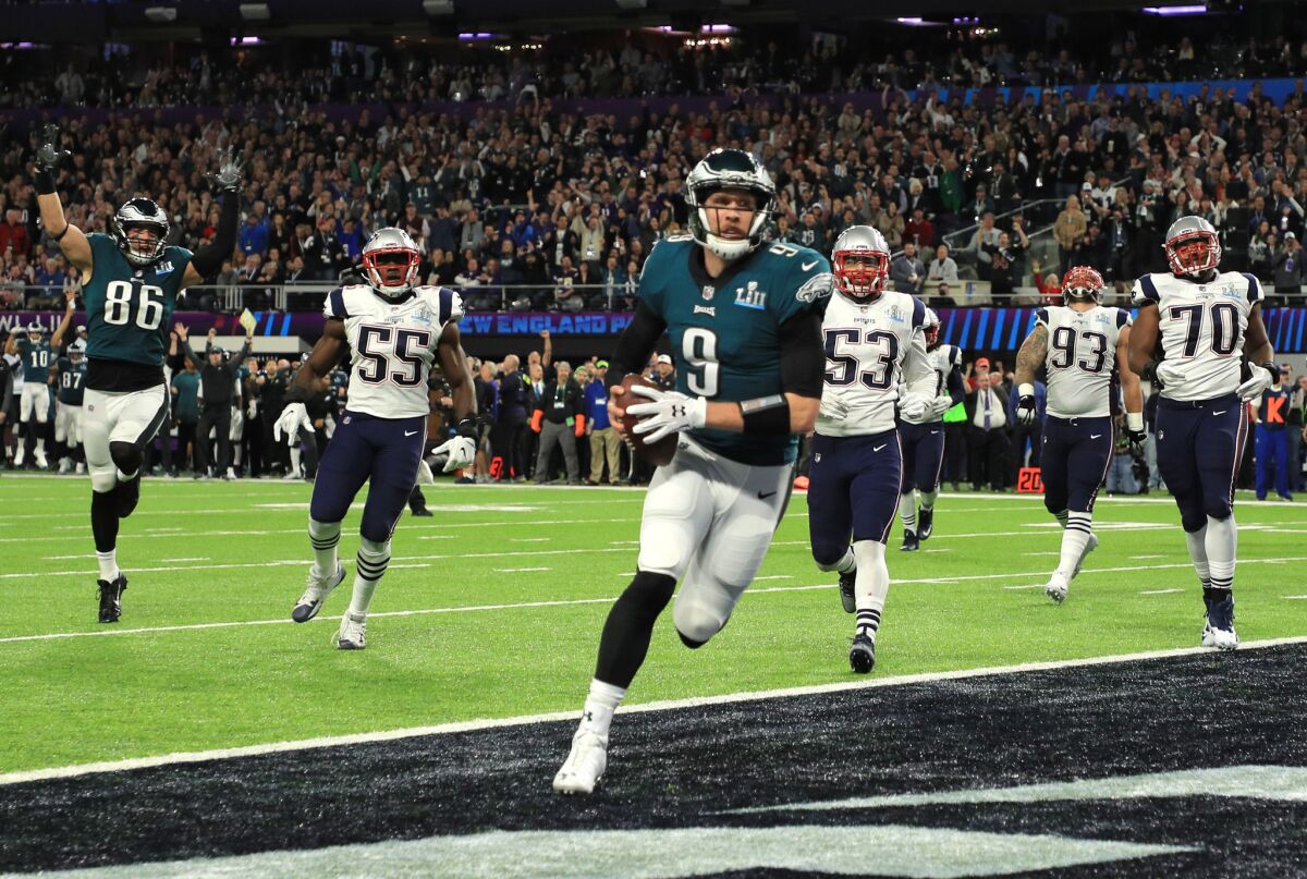 Eagles quarterback Nick Foles (9) catches a one-yard touchdown pass against the New England Patriots during the second quarter of Super Bowl LII.