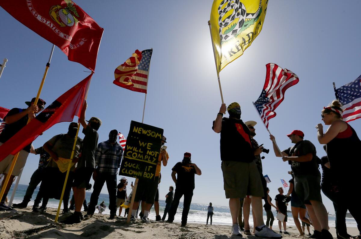 People gather in Laguna Beach in May to protest Gov. Gavin Newson's order temporarily closing Orange County beaches 