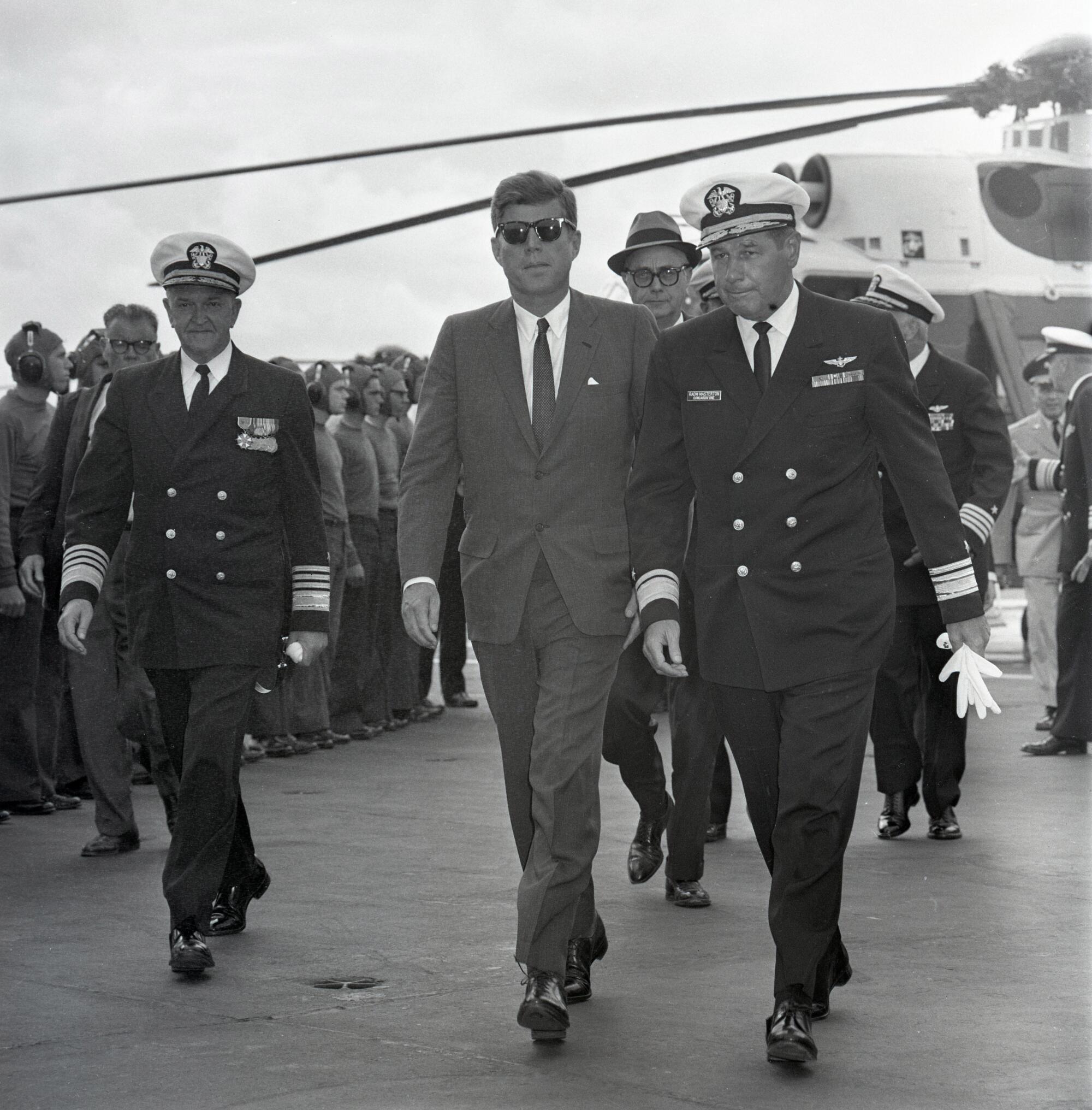 President Kennedy walks with Rear Adm. Paul Masterton
