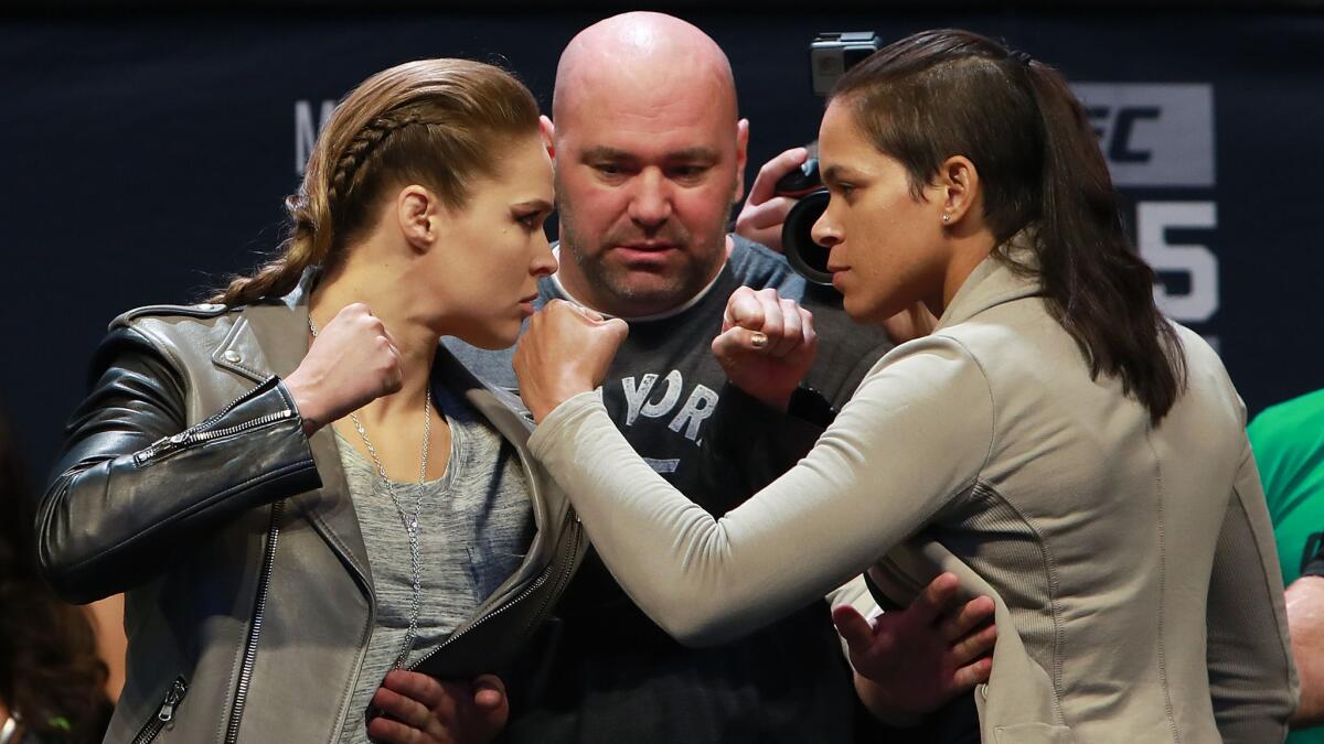 Ronda Rousey, left, and Amanda Nunes are joined by UFC President Dana White on Nov. 11 as they promote their UFC 207 main event.