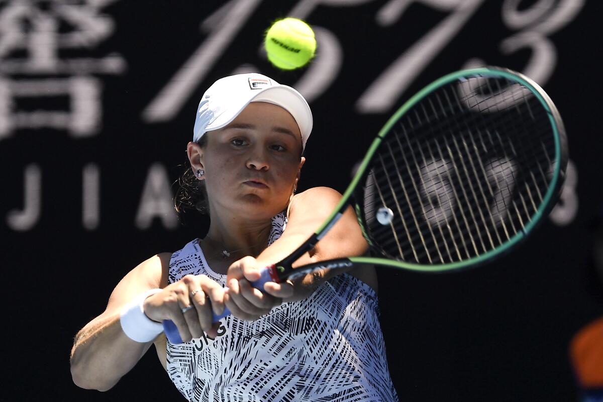 Ash Barty plays a backhand return to Lucia Bronzetti.