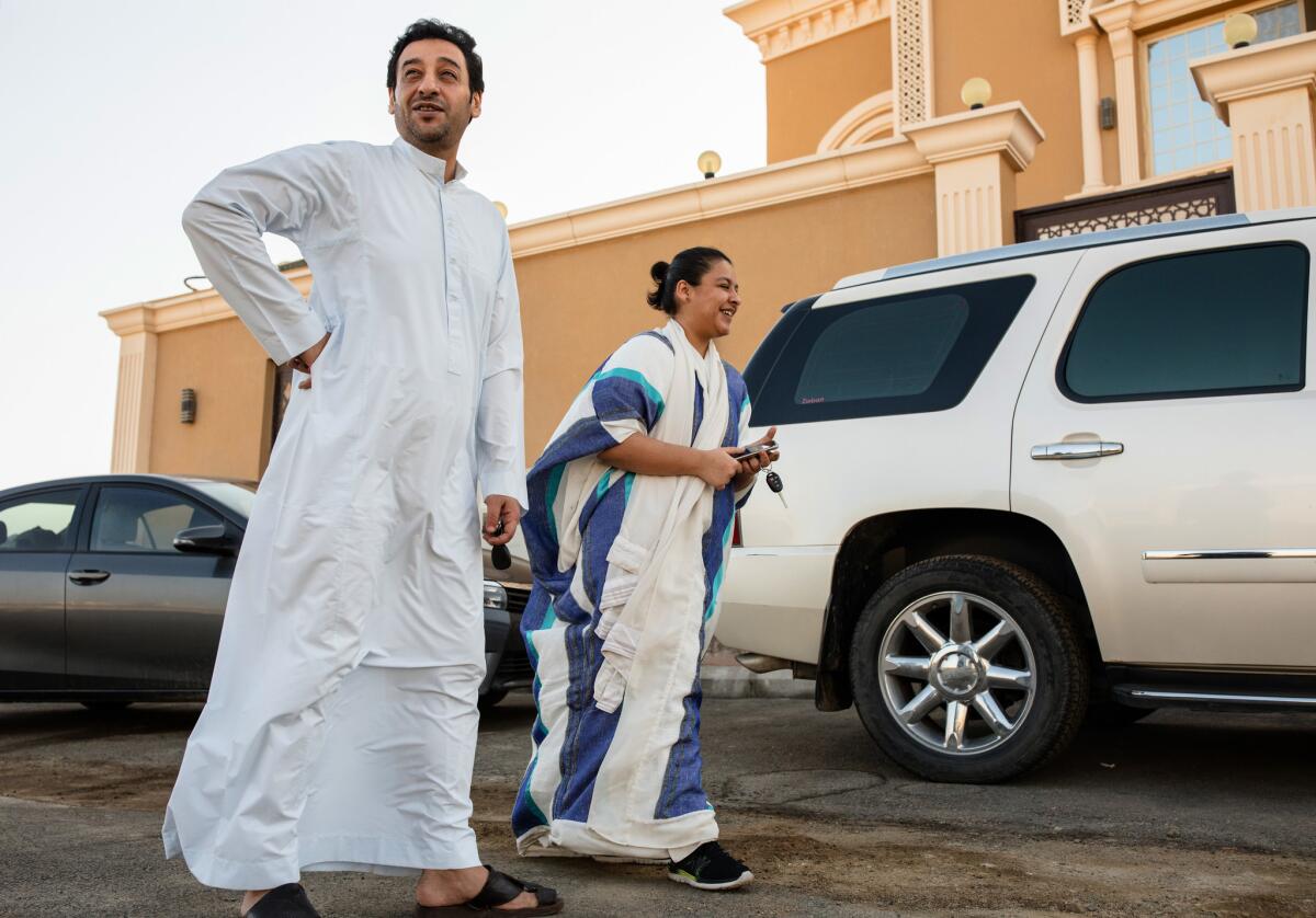 Tala Murad, a Saudi university student, and her father, Midhat, in front of their home in a northern suburb of Jidda. She is learning to drive so she can work for a regional smartphone-based ride-hailing service.