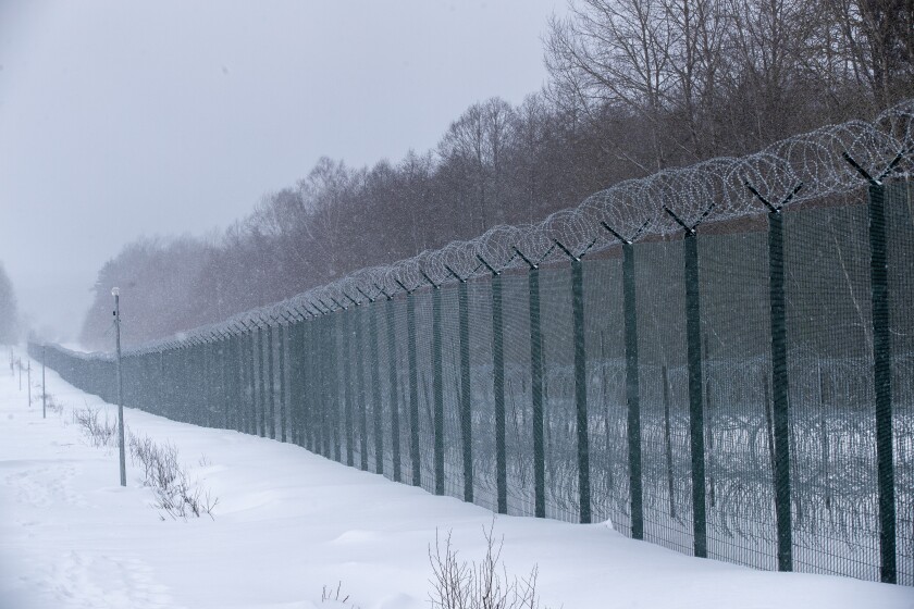 A view of the four-meter-high fence on the Lithuanian-Belarusian border during a visit by participants of the Conference on Border Management near the village Kurmelionys, some 40km (24 miles) east of the capital Vilnius, Lithuania, Friday, Jan. 21, 2022. (AP Photo/Mindaugas Kulbis)