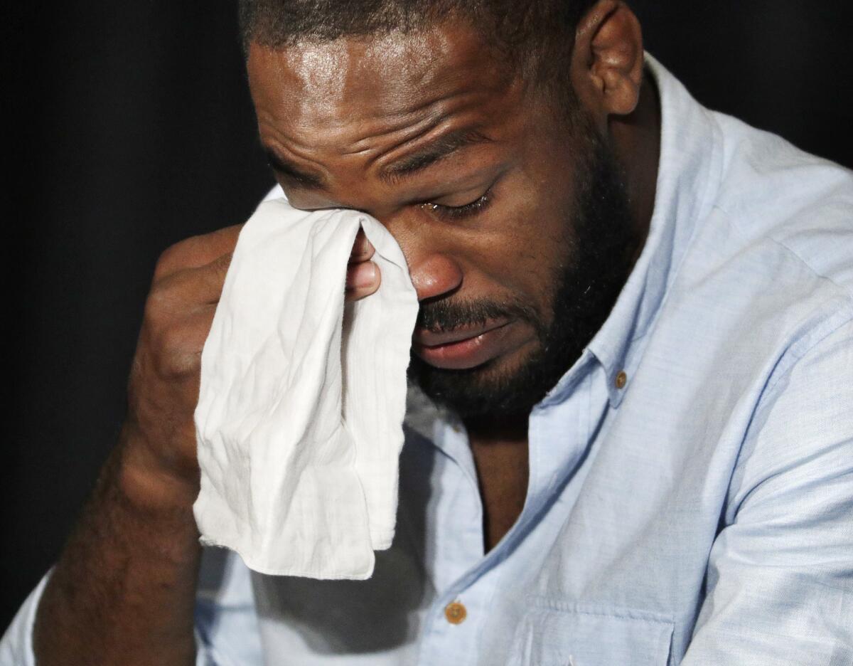 Jon Jones tears up during a news conference Thursday.