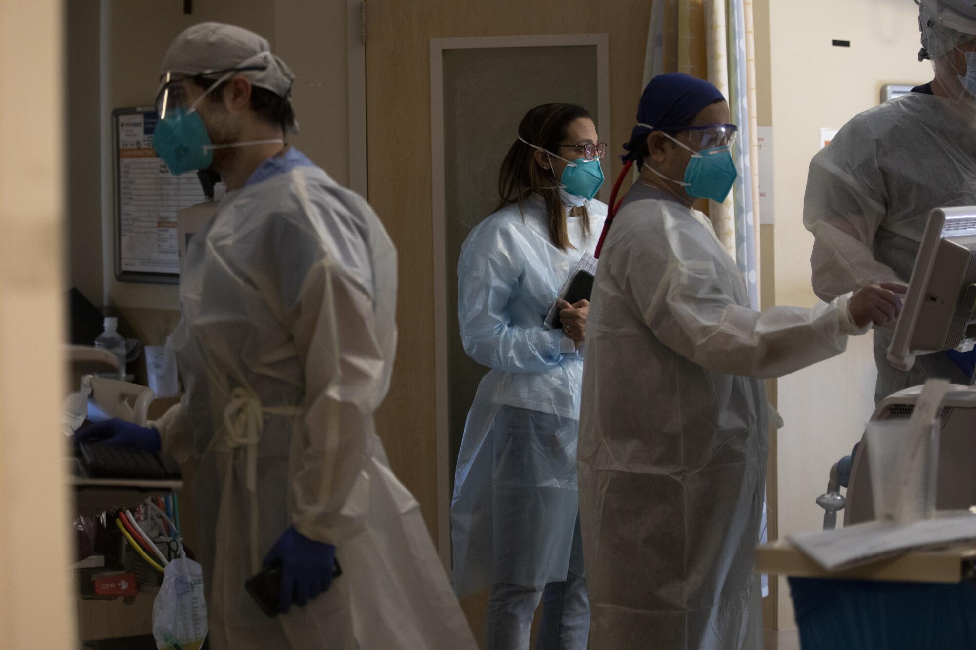 Dr. Marwa Kilani,  at work along side other caregivers inside the COVID ICU. 