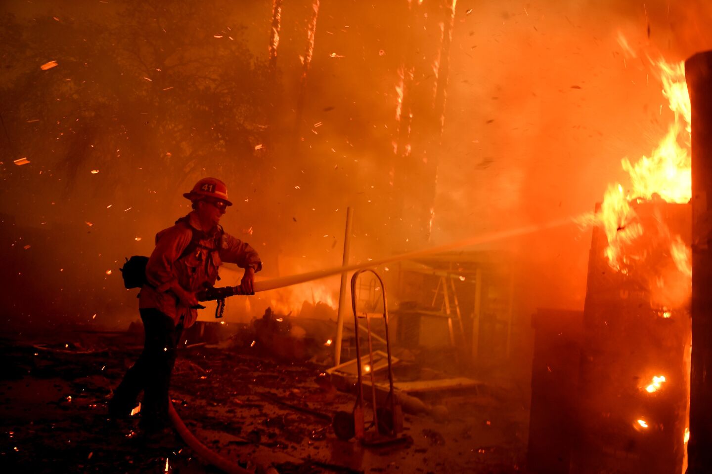 A firefighter battles the Thomas fire along Highway 33 in Casitas Springs.