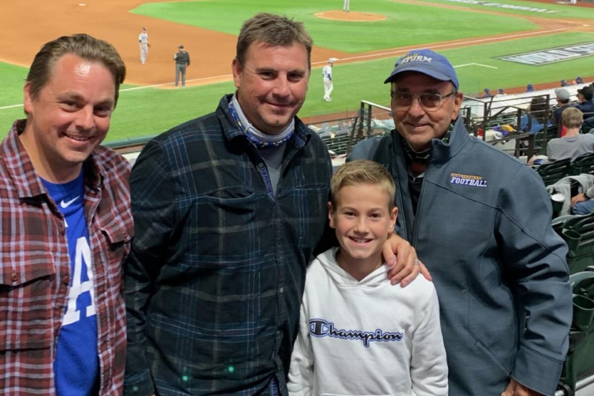 Jim Fenwick with sons Casey and Tyler and grandson Kayden in the stands at the Dodgers' World Series final in Texas.