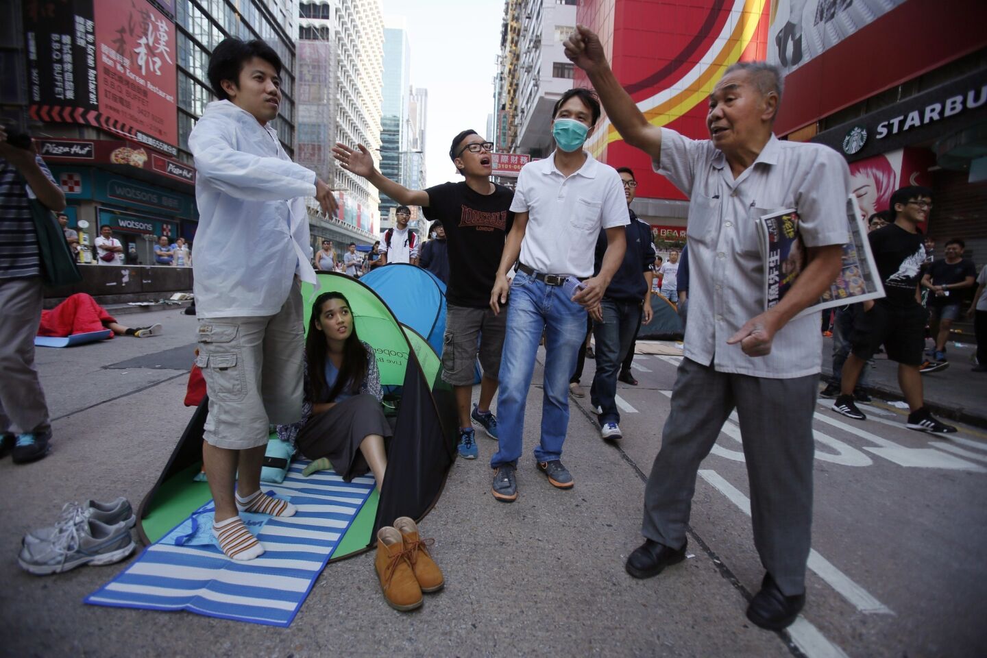 An older man shares his opposing views with pro-democracy student protesters in Mong Kok.