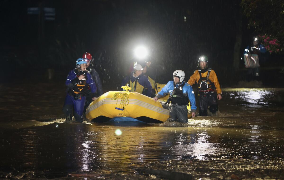 Emergency workers use an inflatable boat to rescue stranded residents in Nelson, New Zealand, Wednesday, Aug. 17, 2022. Heavy rain continued to pelt New Zealand causing further disruptions and road closures from a storm that has already forced hundreds of people to evacuate their homes. (George Heard/New Zealand Herald via AP)