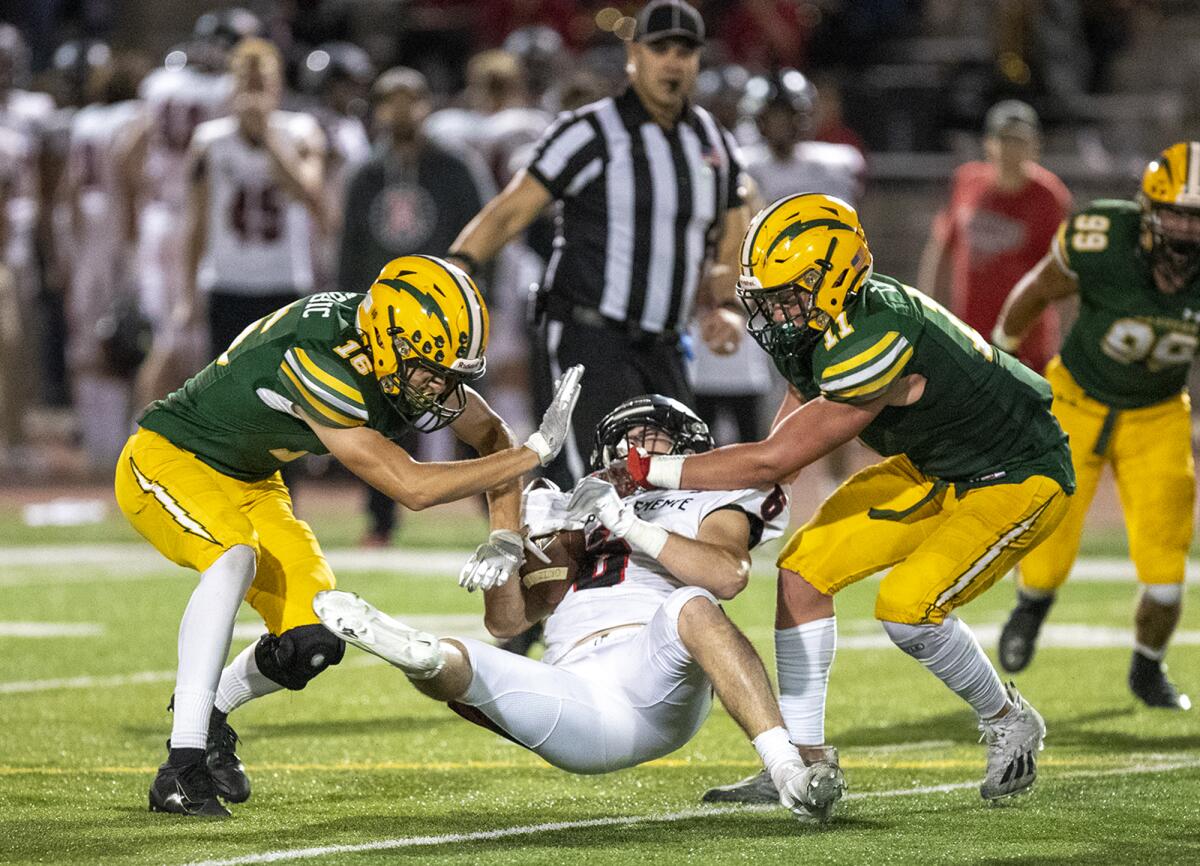 Edison's Cody Grbic, left, and Dom Lopez tackle San Clemente's Blake Allen.