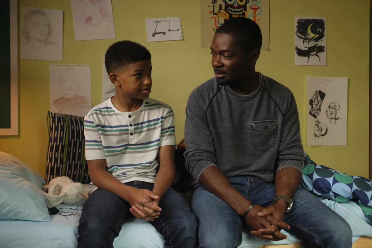 Lonnie Chavis, left, and David Oyeylowo sit on a bed in "The Water Man."