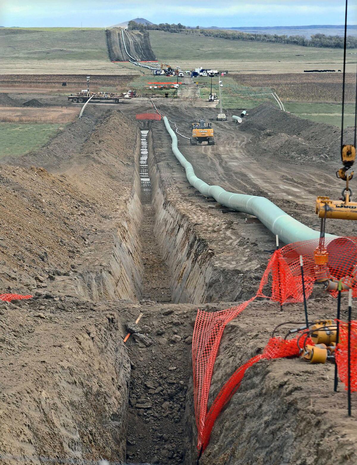 FILE - In this October 2016 file photo, construction continues on the Dakota Access pipeline. A hearing was scheduled for Friday, April 9, 2021, to determine whether the Dakota Access oil pipeline should be allowed to continue operating without a key permit while the U.S. Army Corps of Engineers conducts an environmental review on the project. (Tom Stromme/The Bismarck Tribune via AP, File)