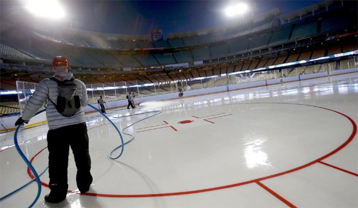 Workers prepare an outdoor ice rink at Dodger Stadium for the Kings-Ducks matchup Saturday as part of the NHL's Stadium Series.