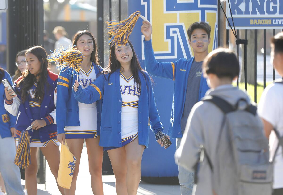 Members of the cheer squad greet students at Fountain Valley High on Wednesday.
