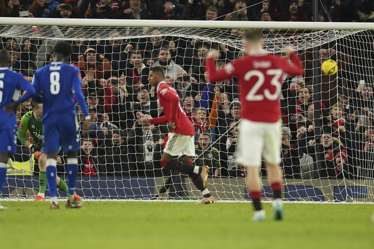 Manchester United's Marcus Rashford, center, scores a penalty, the third goal of his team during the English FA Cup soccer match between Manchester United and Everton at Old Trafford in Manchester, England, Friday, Jan. 6, 2023. (AP Photo/Dave Thompson)