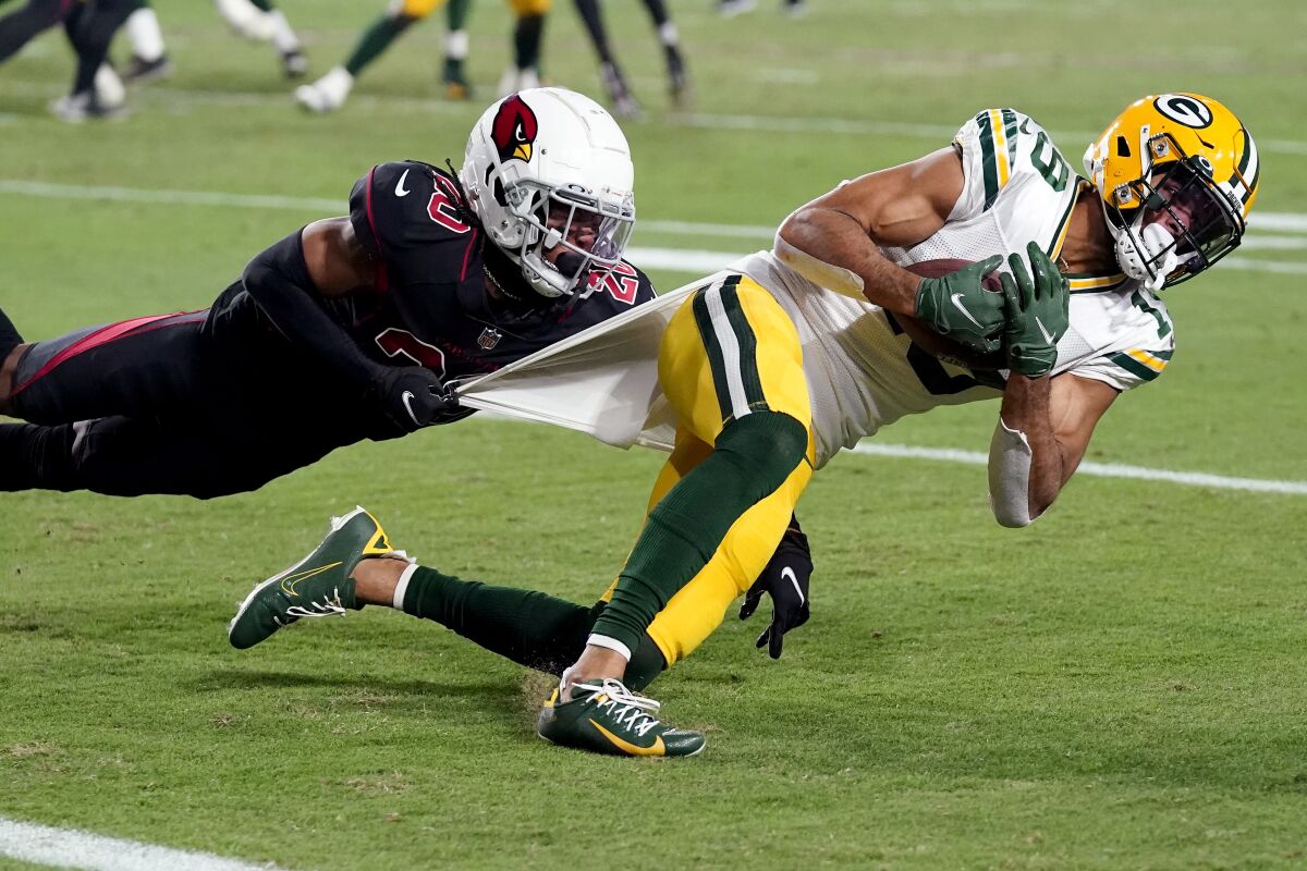 Green Bay Packers wide receiver Amari Rodgers (8) is tackled by Arizona Cardinals cornerback Marco Wilson (20) during the second half of an NFL football game, Thursday, Oct. 28, 2021, in Glendale, Ariz. (AP Photo/Ross D. Franklin)