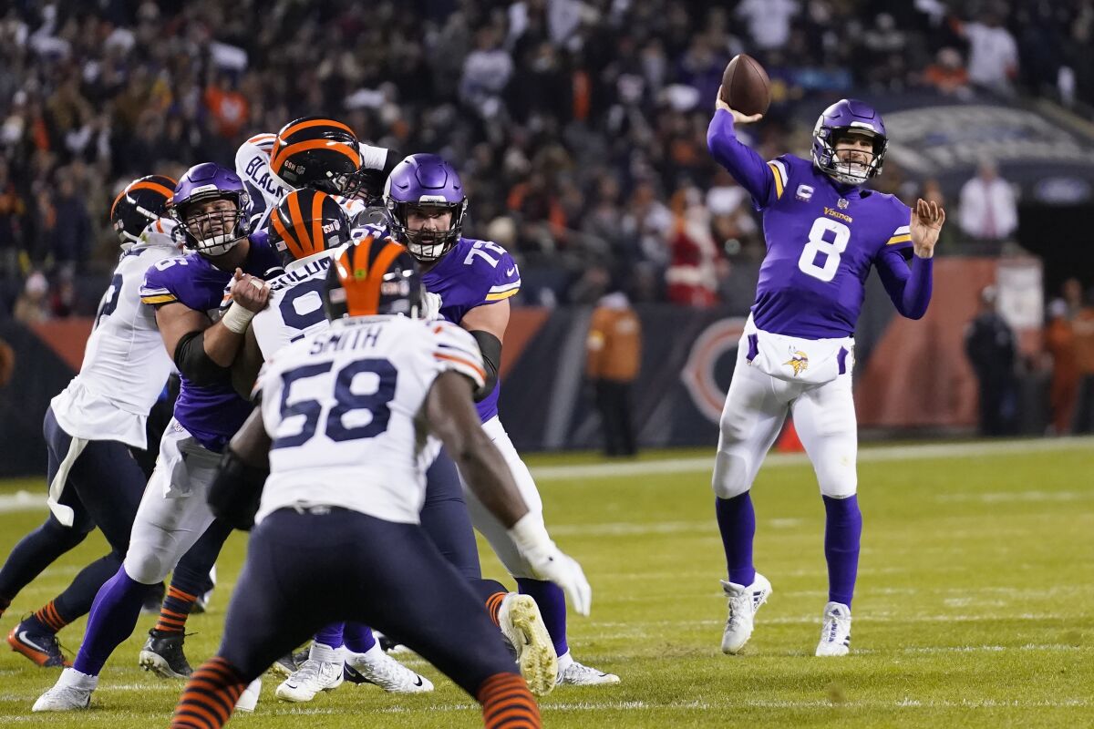 Minnesota Vikings quarterback Kirk Cousins throws a touchdown pass to Justin Jefferson during the first half of an NFL football game against the Chicago Bears Monday, Dec. 20, 2021, in Chicago. (AP Photo/Nam Y. Huh)