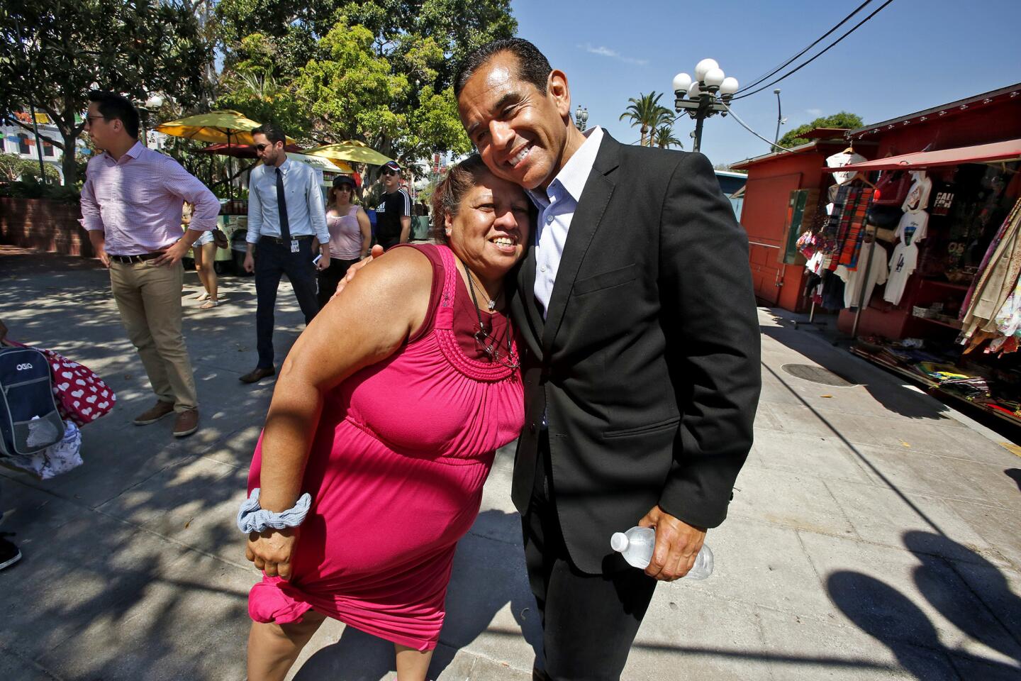 Alida Gonzalez hugs outgoing Los Angeles Mayor Antonio Villaraigosa at Placita Olvera.