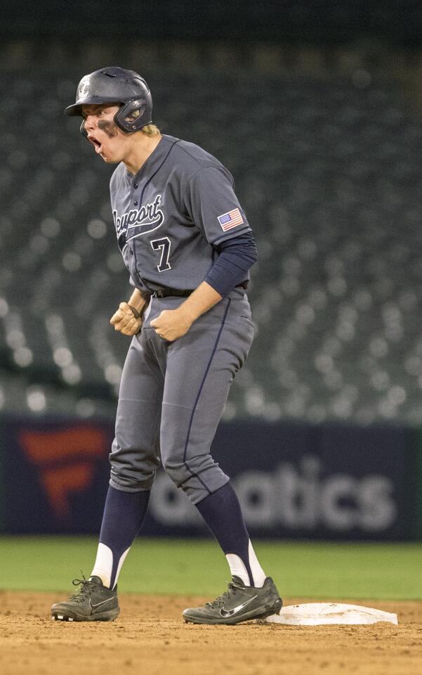 Newport Harbor's Clay Liolios celebrates after hitting a two-run double in the fifth inning during a Sunset League game against Marina at Angel Stadium on Tuesday, March 27.