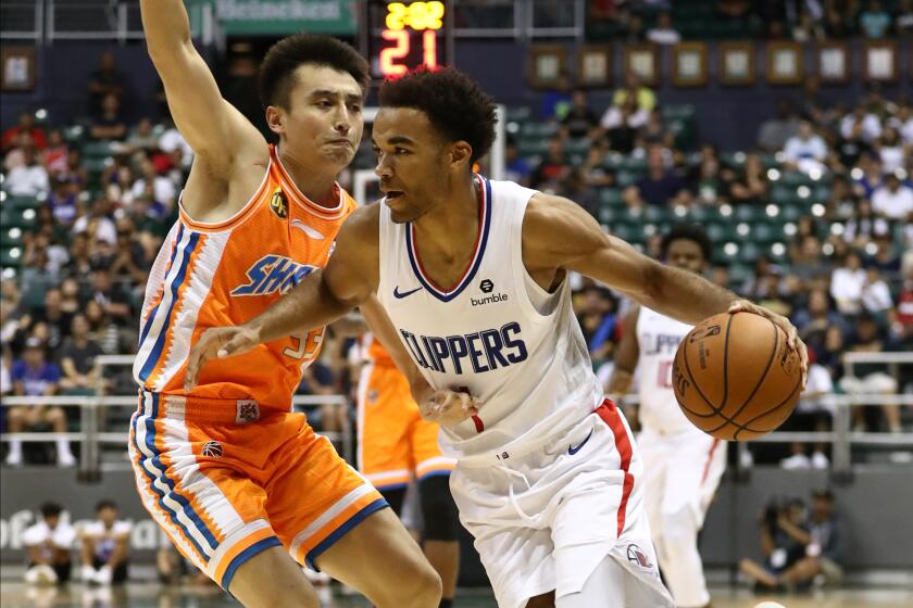 HONOLULU, HI - OCTOBER 06: Jerome Robinson #1 of the Los Angeles Clippers drives past Luo Hanchen #33 of the Shanghai Sharks during the third quarter of the game at the Stan Sheriff Center on October 6, 2019 in Honolulu, Hawaii. TO USER: User expressly acknowledges and agrees that, by downloading and/or using this photograph, user is consenting to the terms and conditions of the Getty Images License Agreement. (Photo by Darryl Oumi/Getty Images)