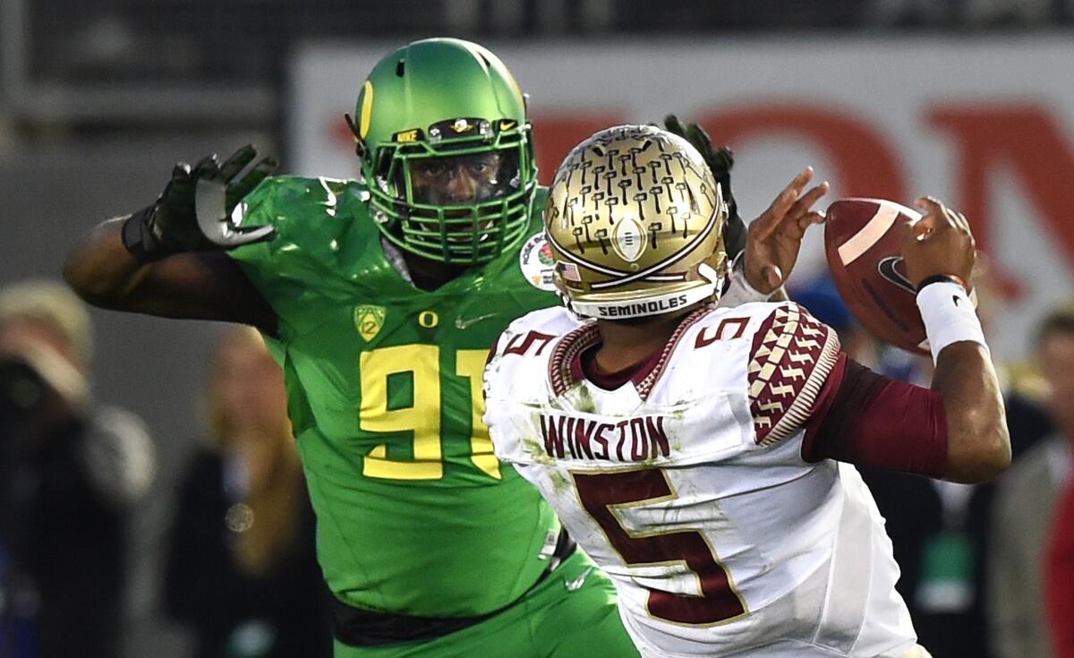 Florida State quarterback Jameis Winston stumbles and fumbles while trying to escape the pressure of Oregon linebacker Tony Washington in the third quarter of Thursday night's Rose Bowl.