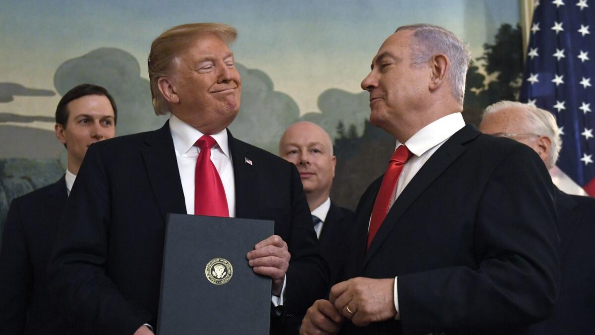 President Donald Trump smiles at Israeli Prime Minister Benjamin Netanyahu, right, at the White House in Washington on March 25.