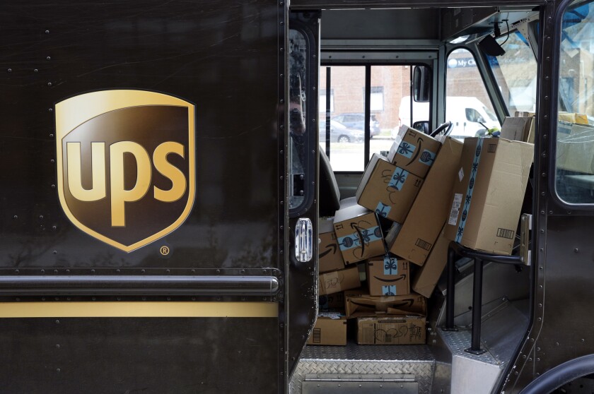 FILE - In this Dec. 19, 2018 file photo, packages await delivery inside of a UPS truck in Baltimore. UPS is buying 10 electric vertical aircraft from Beta Technologies as it looks to get items to small and mid-size markets faster. In an announcement Wednesday, April 7, 2021 Atlanta delivery company said it will test the eVTOLs for use in its Express Air delivery network. (AP Photo/Patrick Semansky, File)
