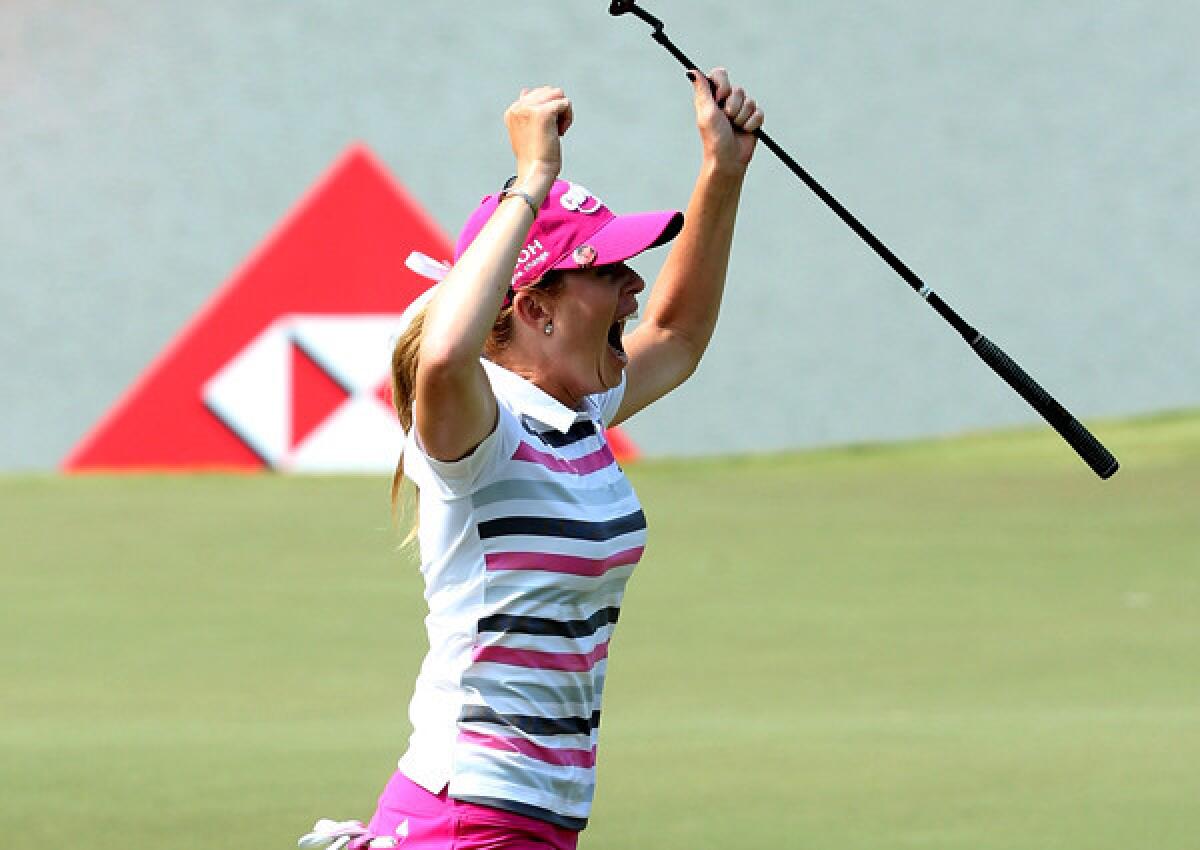 Paula Creamer reacts after making a 75-foot eagle putt to defeat Azahara Munoz in a playoff for the HSBC Women's Champions tournament title on Sunday in Singapore.